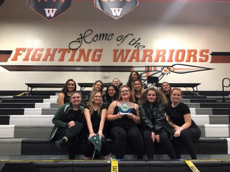 Containing their excitement, color guard poses for the camera after winning first place.
