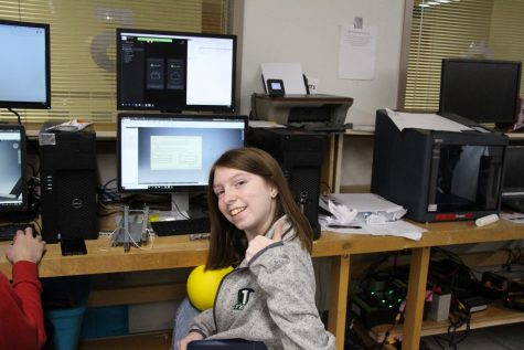 Sophomore Barbara Sylvester smiles at the camera as she designs the drive train of the robot. The robotics team is working on a new robot for this build season.