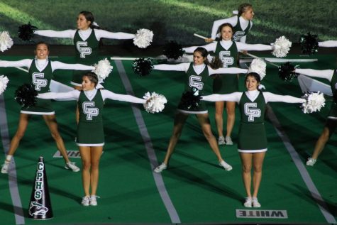 With a strong stance, the varsity cheer team performs at state on Jan 16. Cheering at the their first National Cheer Championship and overall placing eighth in the nation, exceeded the team's expectations.