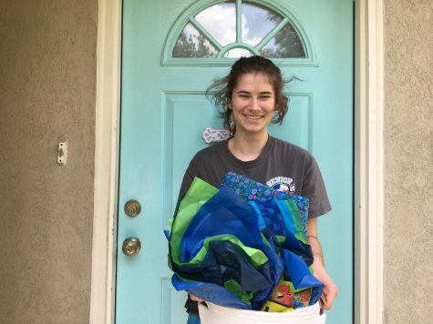 Holding her basket of gifts, senior Sarah Rodriguez thanks her adoption family.