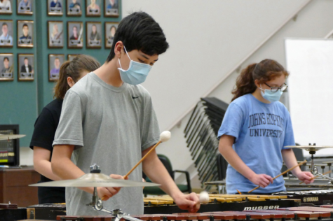 Sophomore Kai Gray rehearses drumline show music while keeping in line with quarantine measures. Gray, and the rest of the percussion section, came back on Aug. 24. “Once we’re together playing music, I don’t really pay attention to the masks or distancing, and things feel pretty normal,” Gray said.