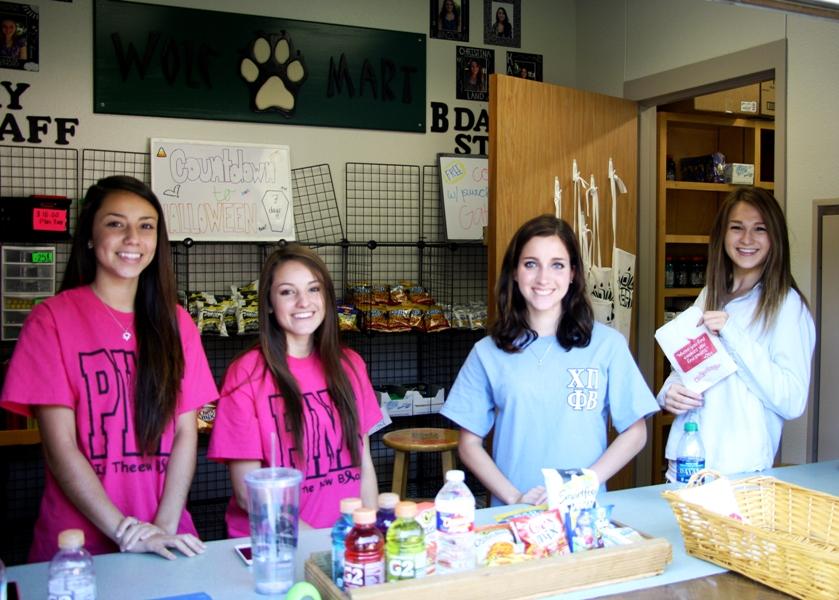 DECA members run the Wolfmart every day during both lunches.
Left to Right: seniors Alyssa Cepeda, Christina Lanzoni, Katie Wane, and Christina Land