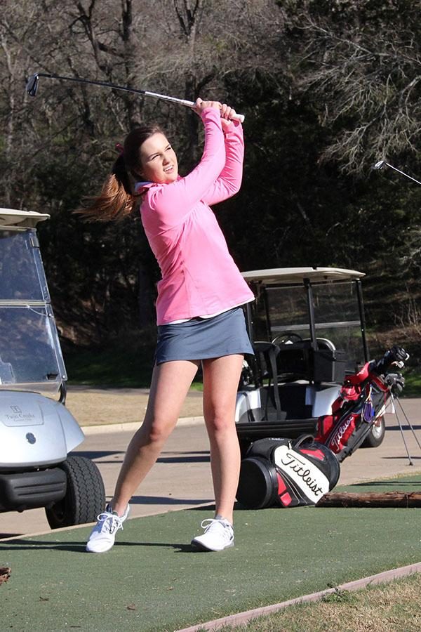 Sophomore Addison English swings her club, practicing for upcoming golf tournaments.  “I like how golf is an individual sport, but at the same time you play as a team,” English said. “We play off of each other and it’s good for bonding.”