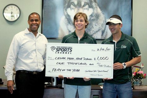 A Time Warner Cable rep presents junior Tommy Lavine and senior Amir Alzer with a $1000 check on Feb. 12 for winning the