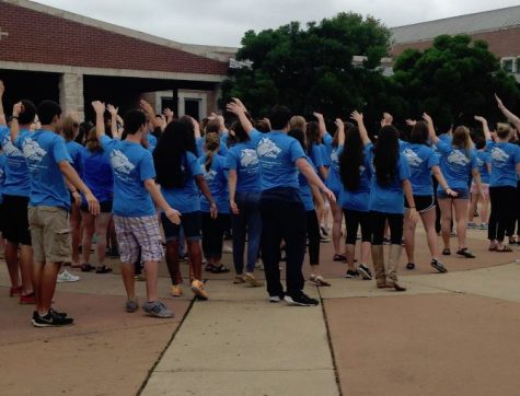 Pre-calculus student Max Hein (pictured second from left) performs in the courtyard flash mob, using his hands to make the curve of a graph. “I really enjoyed the choice of music,” Hein said. “Uptown Funk is actually one of the few modern songs I respect, because it’s super funky, and also uptown.”