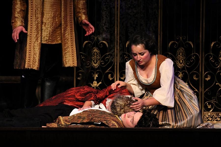 Watching her love, Theogenes, played by sophmore Daniel Williamson, die, Hippolyta, played by senior Collyn Burke, falls atop him and begins to weep. Watching her mistress in tears, Clarina, played by senior Ayah Alomari, comforts Hippolyta.