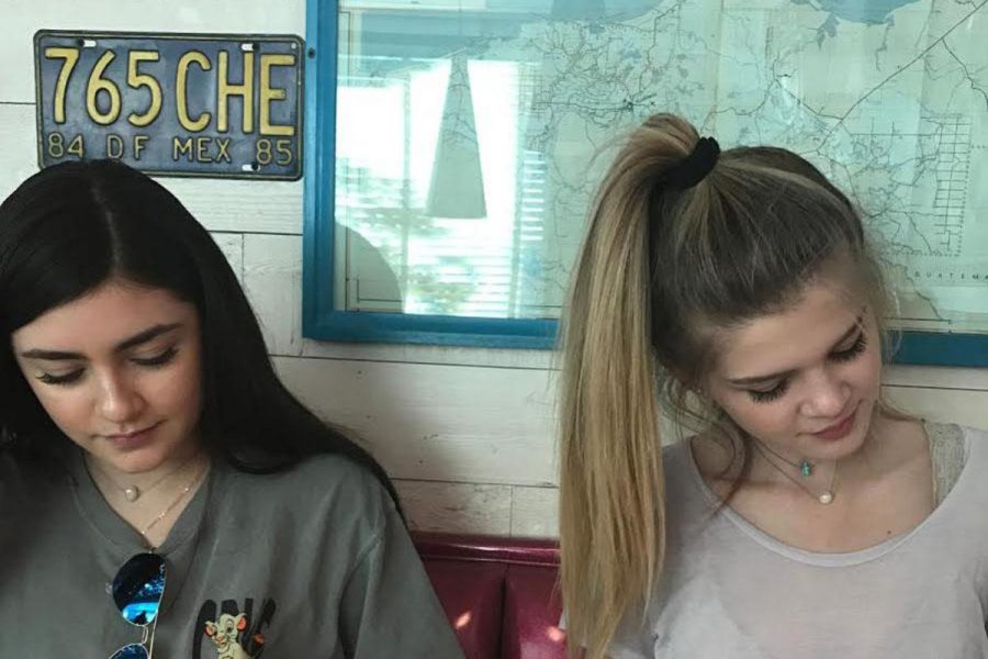 While at the grand opening of Chuys, senior Vannesa Martinez and Hanna Stapleton look over the menu. 