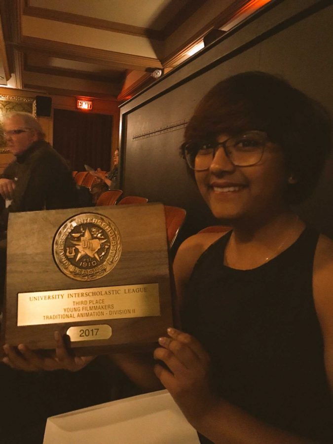 Cheryl Cruz, 11, receives her award for her film Morpho at the Paramount Theater.