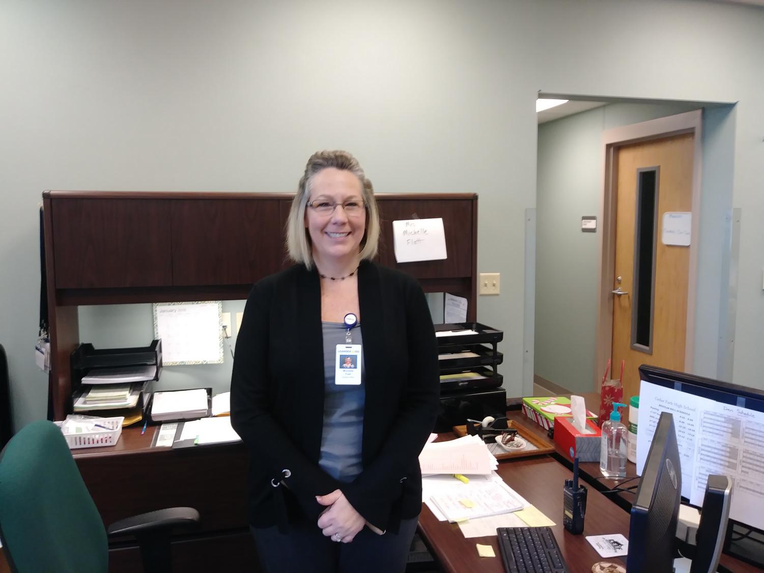 Michelle Flatt, the new Administrative Assistant for the AP's office, takes the place of Lynda Mcfarland at the desk at the front of the AP's office.