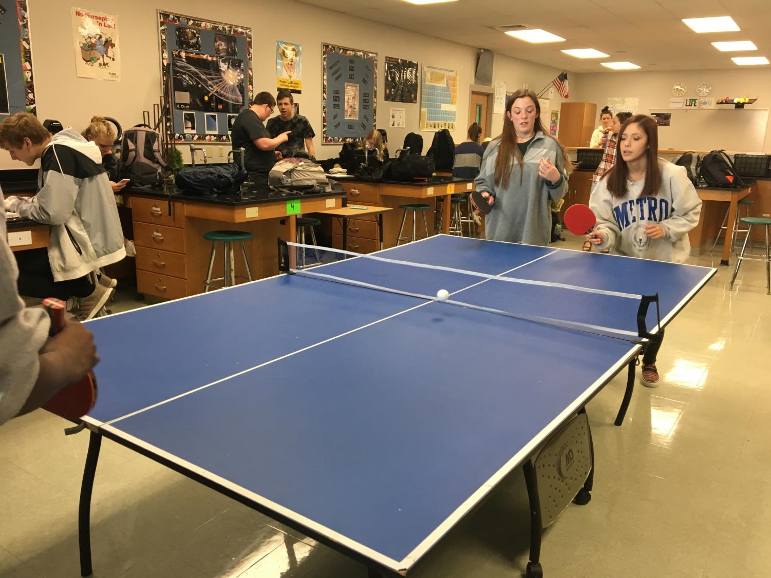 Junior Kasey Korbakes and sophomore Lolah Colins play a game of ping pong in ping pong club on Jan. 12.