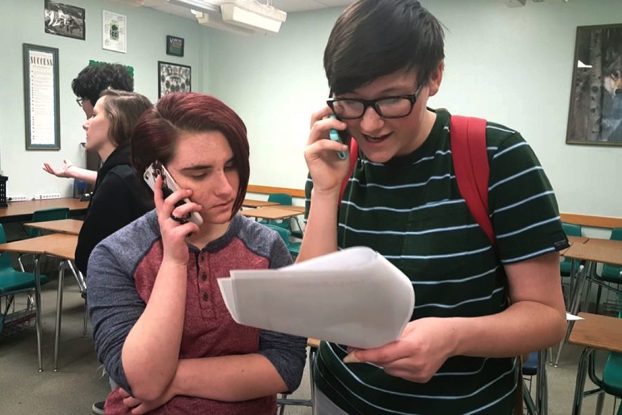 Reading off of a short script, freshman Peyton Fehrenbach and junior Kaitlin Cantwell call their representative. They were some of the 20 GSA members who called about immigration on Jan. 9 in AW109.