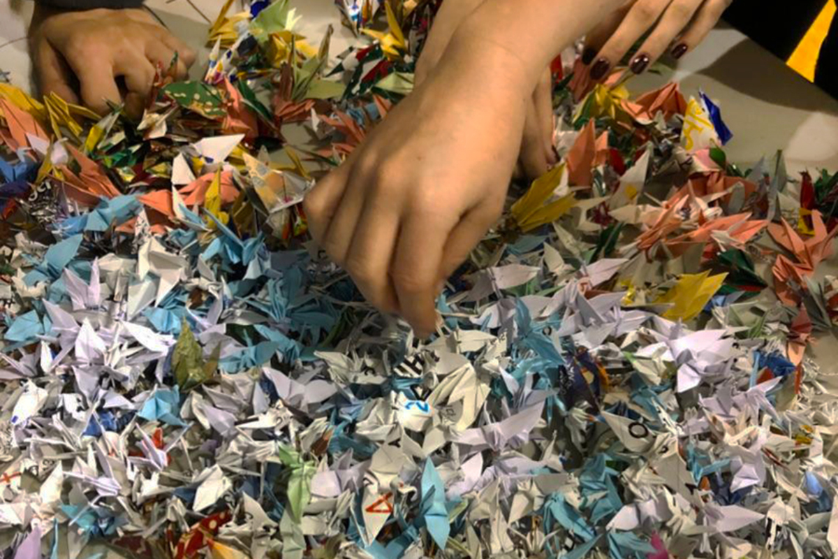 Rooting through the 2,000 paper cranes Sue Stifflemire made for coach Stacy Danielson, dancers were in awe. Junior Becca Thiemann said the kind act meant a lot to her and the team.