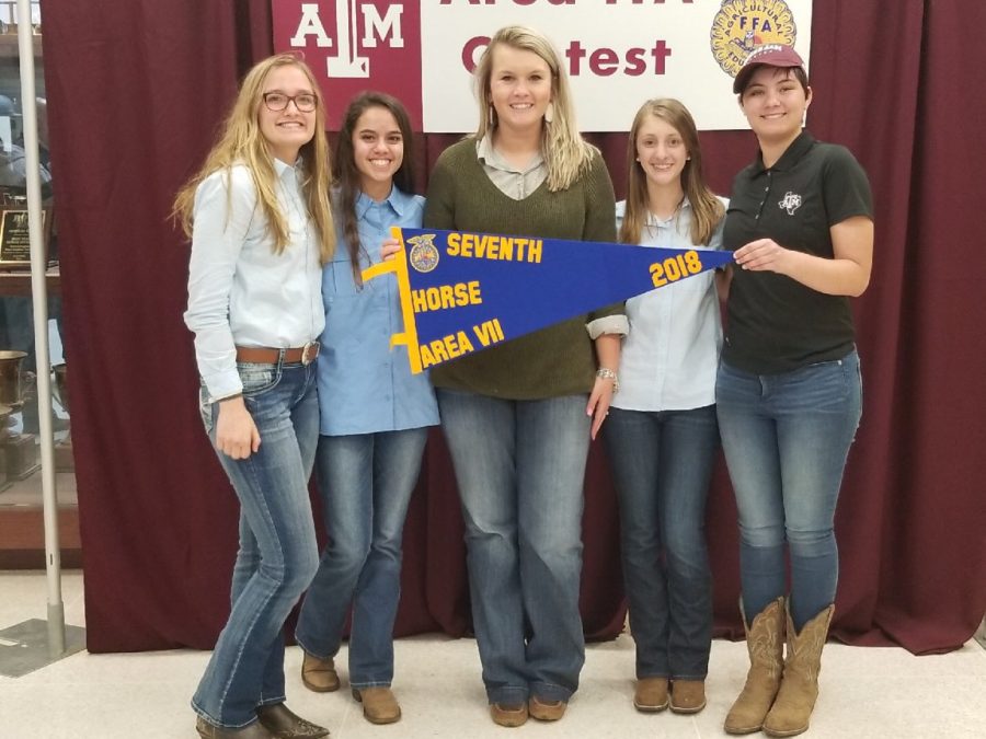 The horse judging team and coach receive their seventh place prize for their performance at the area meet. 