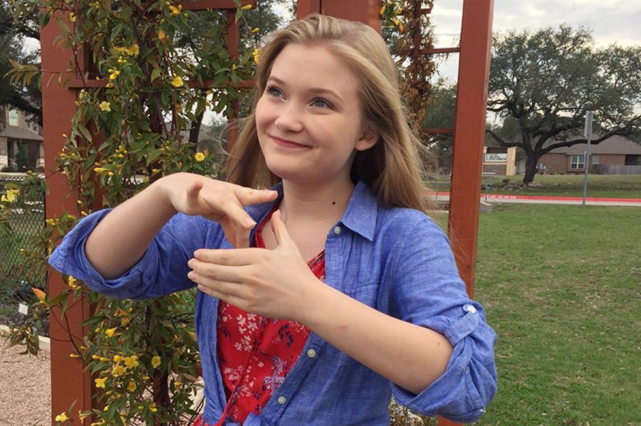 Freshman Sydney Solberg signs her favorite ASL sign, tea. 