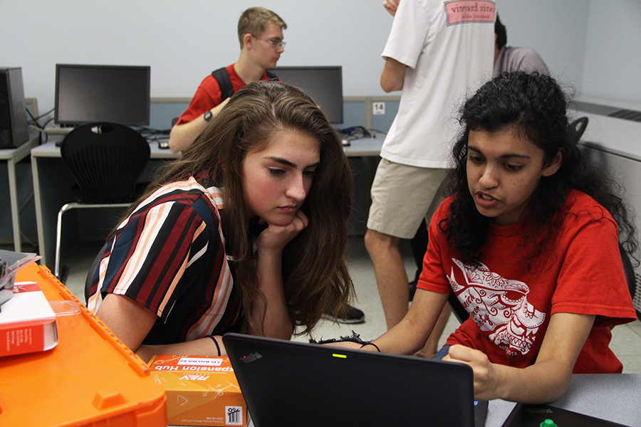 Intently listening, junior Makya Jordan learns about this year's FTC challenge from senior Himaani Ramesh. Ramesh started an all girls FTC team to empower women in STEM.