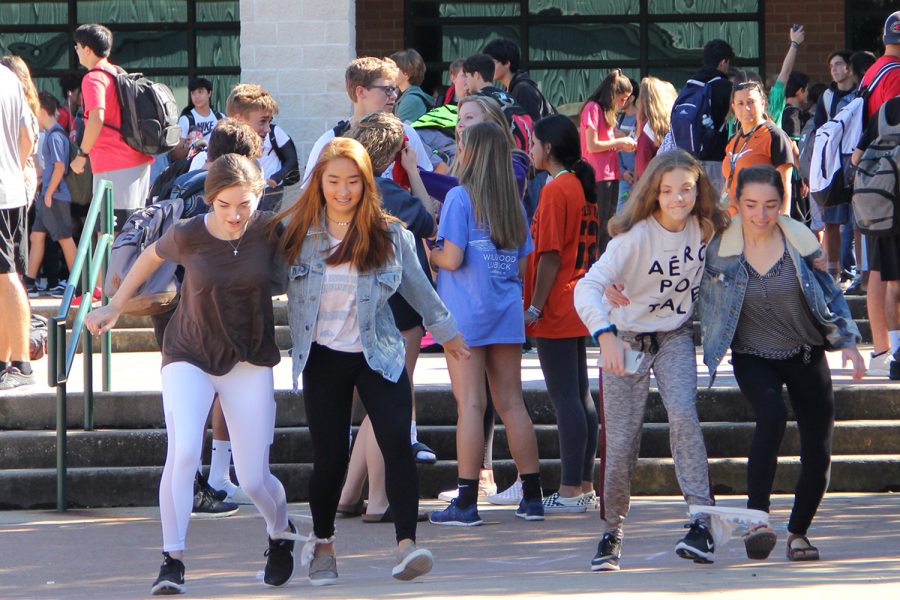 Running in a three-legged race, students participate in the Oct. 10 PACKtivity in the courtyard.
