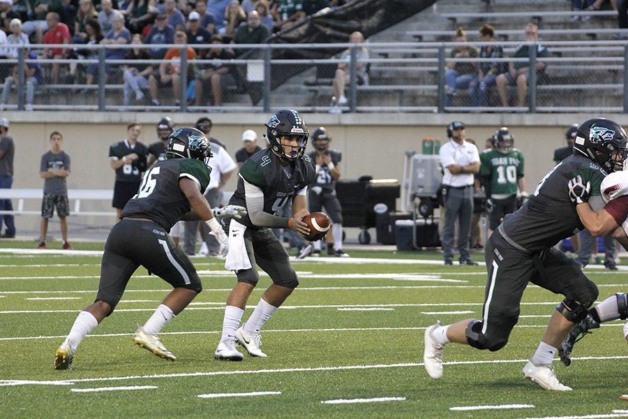 Sophomore QB Ryder Hernandez reads the defense during a run-pass option play 9/28 against Rouse. We were super motivated to come out and play our first district game, senior OLB Hutson McGaughan said. We came out ready to win and prepared for success.