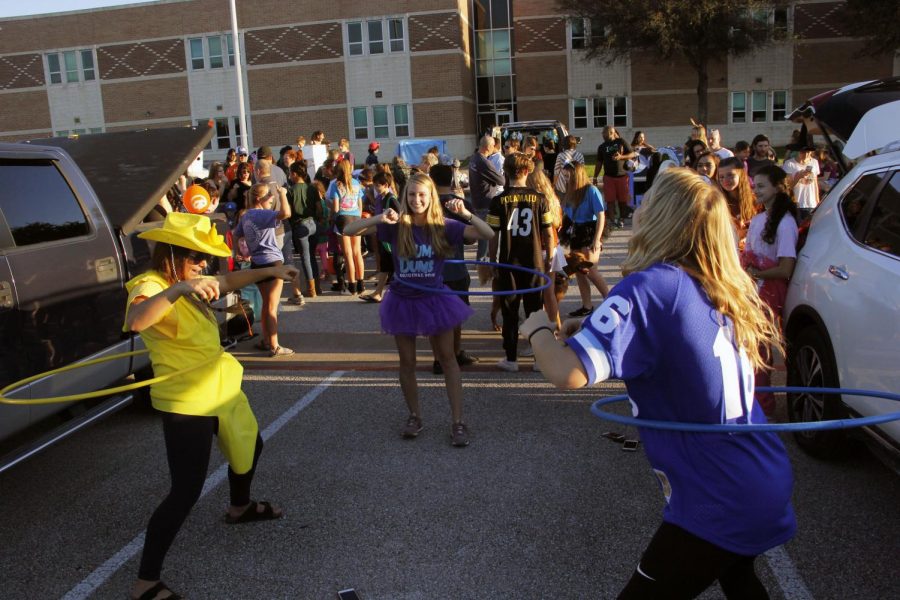 Hula hooping all around, senior Rylee Elam uses her cheer experience to get all the kids excited during Trunk or Treat on Oct. 26. Elam has been in varsity cheer for three years, and said that she was really excited to help out cheer at Trunk or Treat for the first time this year. “Cheer holds a lot of events helping little kids and teaching them how to cheer,” Elam said. “It was nice to see other organizations also giving back to the children in our community.” 