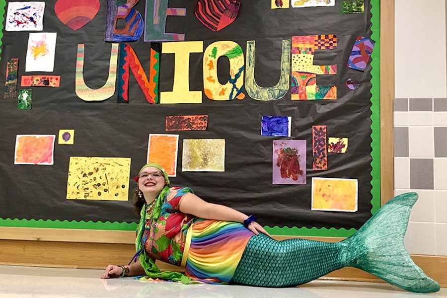 Junior+Loree+Morin+poses+in+her+mermaid+tail+before+school+on+Oct.+23.+Morin+said+that+she+has+always+wanted+to+be+a+mermaid+and+became+a+mermaid+instructor+at+Aquamermaid+School+in+Austin+in+September.+Whenever+youre+in+a+tail+and+youre+swimming%2C+you+just+feel+so+beautiful+and+super+excited%2C+Morin+said.+For+me%2C+the+big+reason+I+want+to+be+a+mermaid+is+to+inspire+people+and+to+make+kids+smile.+