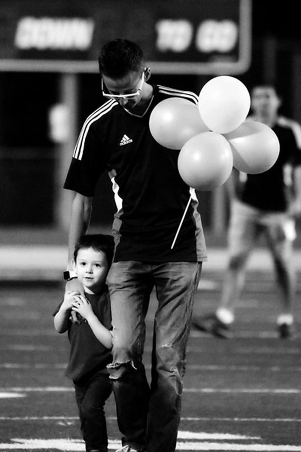 Mr. Yee and his son walk off of the field after a heart warming performance.