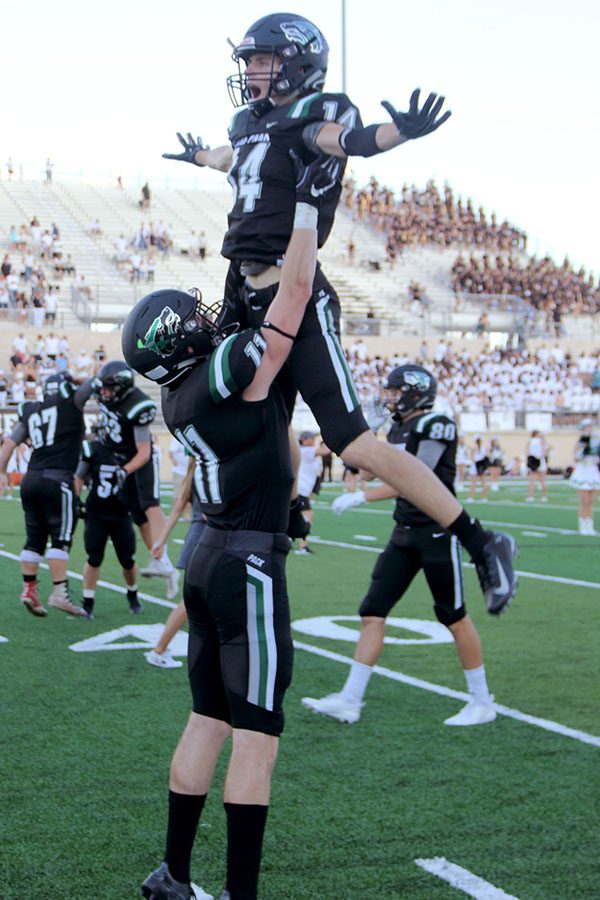 Logan Mayou lifts up Aydon Holley for their pre-game ritual.