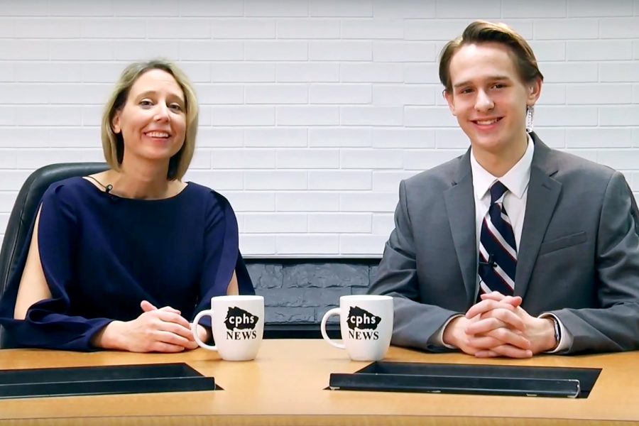 Anchor junior Evan Vines sits with Place 1 trustee, Trish Bode, while filming the The Wolfcast on Jan. 17.