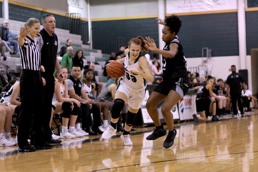 Fighting to get down the court, senior guard Callie Copeland pushes past a Steele defender on Nov. 30. Despite losing to the Knights, the Lady Timberwolves will start district play Dec. 11 with a 12-2 record. “It was a really close game against a 6A team, which was good for our team to have that tough competition right before district,” Copeland said.