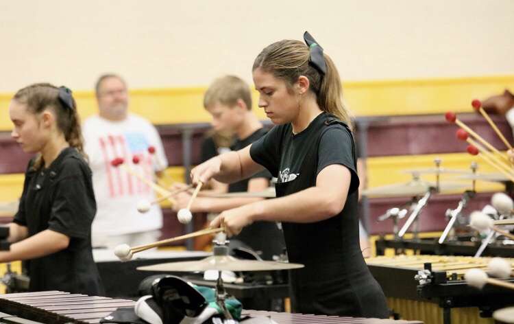 Emily Pumphret focuses in as she warms up before a performance at a Drumline Contest.