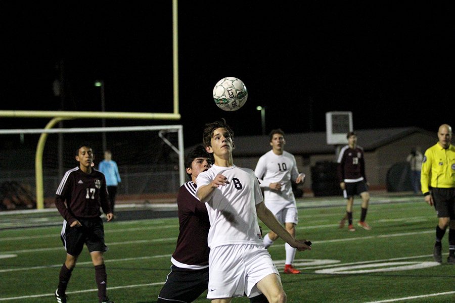 With his eye on the ball senior Jack Dooher runs box to box in his junior year on Jan. 9 against Bastrop. Dooher worked the mid field contributing to the 4-2 win. Playing with such a talented senior class last year was hard to keep up with, Dooher said. Being given the chance to be a captain my junior year really made me want to step up my game.