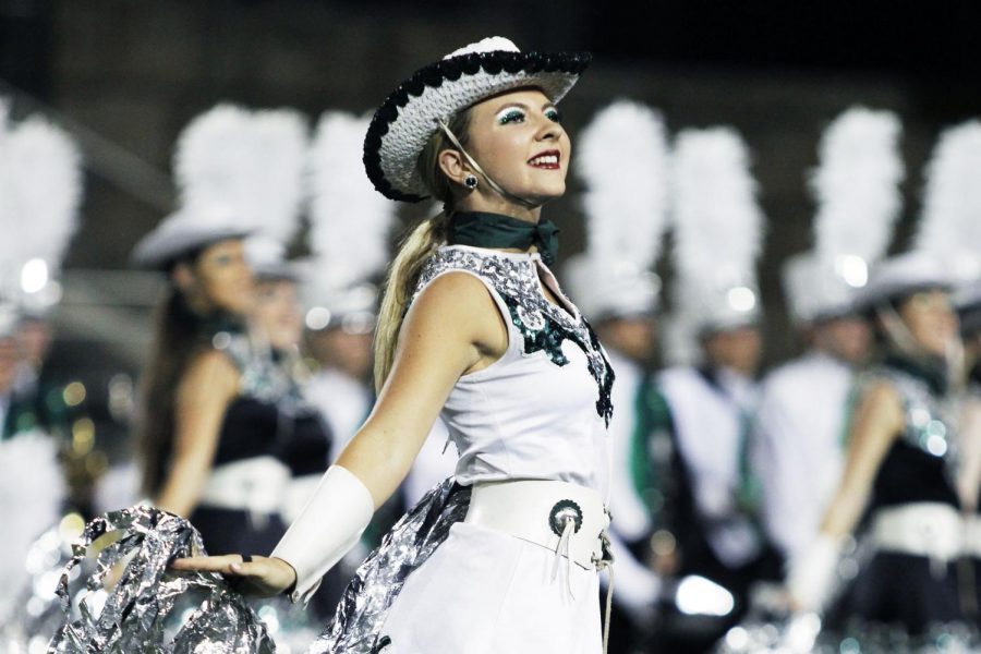 Junior Lacey Hurley smiles proudly at the Cedar Ridge football game while performing with the celebrities. Hurley decided to graduate early this year after discovering that she only needed three more credits to qualify. “I decided to graduate early just because I really felt like it was something that had been on my heart for a while,” Hurley said. “And it was just something that I was really called to and I was just excited.”