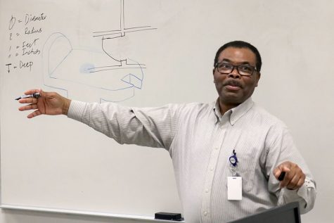 Mr.Madu teaches one of his engineering classes. Madu was an advocate for the school and sponsored seven clubs during his time at CPHS.