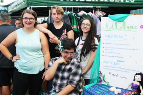 Club president senior Loree Morin and treasurer and secretary junior Efrain Vera III pose with club members junior Sarah Lailson and sophomore Alfred Morin during Meet the Timberwolves on Aug 22. Morin created the mermaid club this year in hopes of promoting the importance of community service.