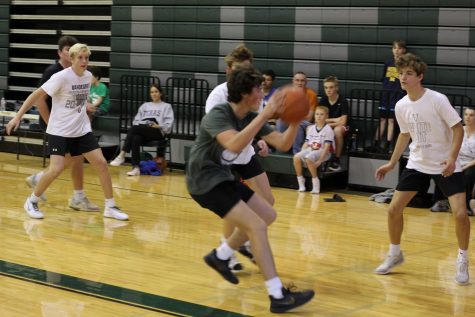 Running down the basketball court, sophomore Landon Langseth attempts to score a shot during the three on three tournament Oct. 26.