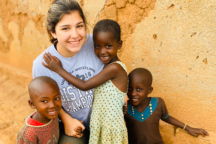Senior+Faith+Elliott+smiles+along+with+three+Rwandan+children+in+the+village+of++Kageyo%2C+Rwanda.+Elliott+volunteers+with+a+group+called+Africa+New+Life+in+Rwanda+and+said+that+the+trip+impacts+her+every+year.+What+surprises+me+the+most+about+the+people+there+is+how+the+Rwandans+can+have+so+little+and+still+be+filled+with+joy.+This+year+was+different+than+the+last+because+I+already+knew+what+to+expect+and+saw+a+lot+of+old+friends+there%2C+it+was+like+I+was+going+back+home.%E2%80%9D%0A