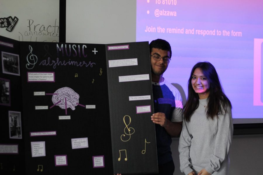 Seniors+Jackie+Castillo+and+Shivesh+Razdan+pose+for+a+picture+during+their+DEN+presentation+over+Alzheimers.+Each+year%2C+Health+Occupations+Students+of+America%2C+also+known+as+HOSA+create+a+project+where+groups+of+students+strive+to+create+a+lasting+effect+on+the+community+through+their+research.+This+year+for+the+annual+HOSA+project%2C+senior+Layla+Ismail+decided+to+use+her+project+to+create+awareness+of+Alzheimers%2C+and+the+link+between+classical+music+and+the+disease.+%E2%80%9CI+think+that+we+as+the+youth+of+our+community+need+to+educate+ourselves+since+we+will+be+the+generation+taking+care+of+our+parents+and+relatives+who+will+later+develop+Alzheimers%2C%E2%80%9D+Ismail+said.+%E2%80%9CIt%E2%80%99s+important+for+people+in+high+school+to+get+involved+with+the+Alzheimers+community+because+it%E2%80%99s+an+extremely+humbling+experience.+It+allows+you+to+realize+how+lucky+you+are+to+be+exactly+where+you+are+in+life+currently.%E2%80%9D%0A