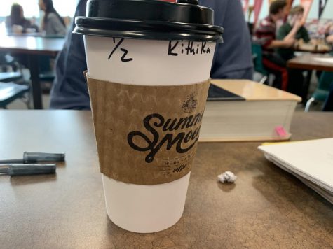 Coffee cup is pictured in a classroom. There are many addictions in society today. Drugs, alcohol and now one that is quiet, but still relevant; caffeine. According to Medical News Today, heavy use of caffeine can cause nervousness, anxiety, jitteriness, sleep problems, gastrointestinal disturbances, tremors and increased heart rate. So while students struggling to balance their busy lives resort to a caffeinated beverage, they are actually putting themselves at risk of something much worse than low energy or sleepiness.