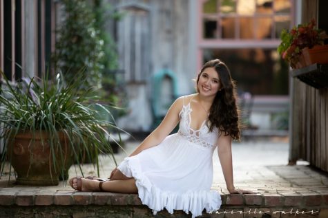 Smiling, senior Lindsay Doves poses for the camera. Dove has played eight theatre roles in her high school career, all varying in genre. However her favorite was Elle Woods in