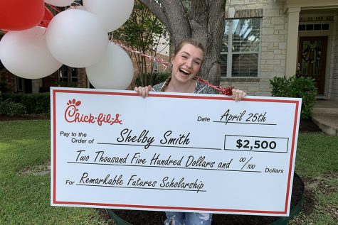 Smiling, senior Shelby Smith holds up her Remarkable Futures check on April 25. Chick-Fil-A staff, along with the cow, surprised her at home with the scholarship.
“Being awarded the scholarship I worked so hard for came to me as a shock, I was so in awe and grateful for the opportunity I had been given and awarded,” Smith said.