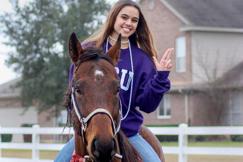 Holding up the Tarleton State University hand sign, senior Abby Mitchell poses for her senior pictures on her horse, Thirsty. Mitchell's family adopted the horse in January 2019 and then began training him. “It's always fun to train Thirsty because I get to see him grow,” Mitchell said. “I like getting to see him learn something we've been working on for a while.”
