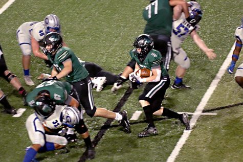 Protecting the ball, senior RB Cade Haught looks for a hole during the Timberwolves 56-24 win over Georgetown on Friday. According to MaxPreps, Haught carried the ball nine times for 81 yards and three touchdowns. “It was pretty surreal, but I was hyped and felt good to be a part of beating Georgetown,” Haught said. “My confidence grew more and more as I ran into that end zone every time.”