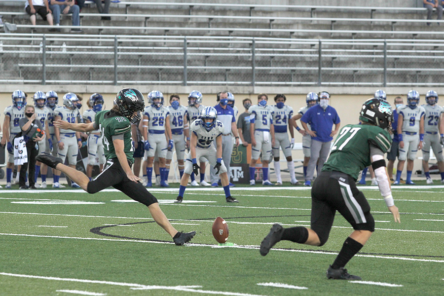 Legs in motion, senior Justin Bohrer kicks the ball downfield in the Homecoming game against Georgetown on Oct. 9. Varsity is currently undefeated and leaves to compete in the 5A state game on Friday, Jan. 15. “I’ve been on varsity for three years now, and this is the best team I have been on by far,” Bohrer said. “I think one of the biggest factors is COVID-19, because every game we get is a blessing and we have been treating football as such a blessing. We have been grinding harder than any other team and another factor [of our success] is the chemistry of the team.”