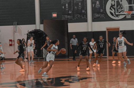 Point guard Gisella Maul dribbles and runs towards the net while playing against members of Cibolo Steel. Although the Nov. 13 game ended in a loss 54 - 56, the girl's varsity team proceeded to win every game in the season afterwards. Maul owes the team's victories to their teamwork and coaching. "I’m proud of my team for always sticking and working together. Most of the credit goes to their efforts and to Coach Ott for always keeping us in top shape," Maul said.