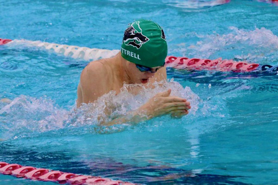 Facing forward, senior Isaac Luttrell swims the 100 breaststroke at the state swim meet. Luttrell finished 12th with a time of 59.68. I was pretty excited to finish off my senior year with state, Luttrell said. It was a lot of fun and an amazing way to end my senior swimming.