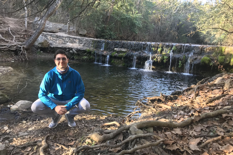 Hiking with his family and dog on Spicewood Valley Trail, senior Kuba Bard poses by the creek. Him and his family went to this trail in January and enjoy hiking frequently. “Hiking helps me regain peace and harmony with nature away from the artificial, digital world,” Bard said.