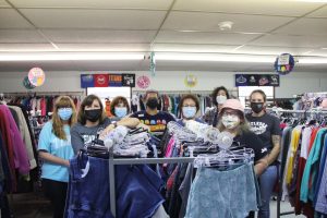 Standing among the clothing racks, the Leander ISD PTA Clothes Closet staff poses for a picture on Oct. 14. Judy Buckner, an experienced community service member who has been helping the Clothes Closet for the past 15 years, said she likes helping students in need. “People do all these things that help people far, far away and that’s great, everyone needs help, but people don’t realize what the need is right here in the community,” Buckner said. “You don’t have to spend all the money on postage to help people, you’ve got people in your own neighborhood who need help.” 
