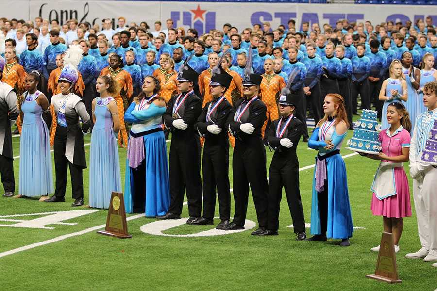 Standing+tall%2C+drum+majors+and+color+guard+display+their+first+place+medals+with+pride+at+the+UIL+State+Competitions+for+band.+This+is+the+fourth+year+in+a+row+that+band+has+been+awarded+first+place+in+the+UIL+5A+competition.+This+is+a+huge+accomplishment+for+our+band%2C+as+it+is+now+our+fourth+consecutive+state+championship+and+our+sixth+overall.+Each+year%2C+this+contest+gets+more+difficult+to+win%2C+as+every+band+keeps+progressing%2C+drum+major+and+junior+Nicholas+Doluisio+said.+We+are+so+happy+that+our+sister+schools+were+able+to+finish+on+the+podium+as+well%2C+as+we+know+theyve+also+worked+incredibly+hard.