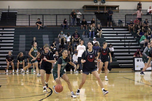 Dribbling, varsity point guard and junior Molly Ly takes the ball down the court against Lake Travis. After earning a state title last year for the first time in school and district history, the team has their sights on winning again this year. “The two main goals this season is another district championship and another run at state with high hopes to repeat,” Ly said. “I think our teams strongest attribute is our ability to play selflessly and our ability to play hard. We do an awesome job of sharing the ball, and we always go one hundred percent even if we are up by 20.”