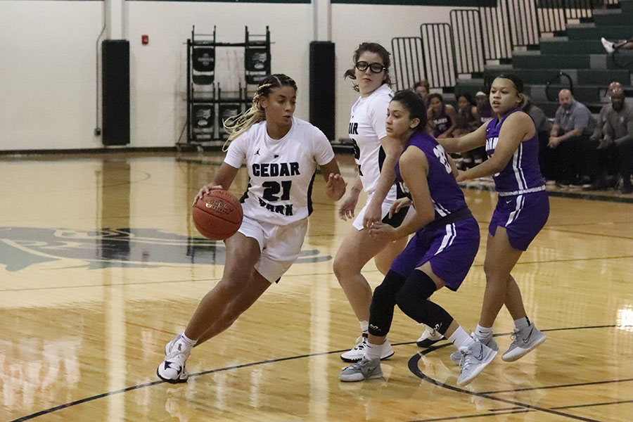 Unyielding+to+the+opposing+team%2C+junior+shooting+and+point+guard+Gisella+Maul+dribbles+down+the+court.+On+Nov.+30%2C+the+varsity+girls+won+their+non-conference%2C+home+game+against+Waco+University+59-29%2C+adding+to+their+overall+17-0+ranking+but+not+contributing+to+district.+%E2%80%9CI+feel+like+we%E2%80%99ve+had+a+pretty+tough+schedule+and+they+are+all+really+good+teams+that+we%E2%80%99ve+played%2C%E2%80%9D+Maul+said.+%E2%80%9CIf+anything+the+focus+is+more+real+%5Bthis+year%5D.+We+still+have+something+to+prove+and+so+we%E2%80%99ve+been+more+focused+and+more+determined+because+we+know+that+we%E2%80%99re+not+just+satisfied+with+winning+one+state+championship%2C+we+have+bigger+goals+in+mind.%E2%80%9D