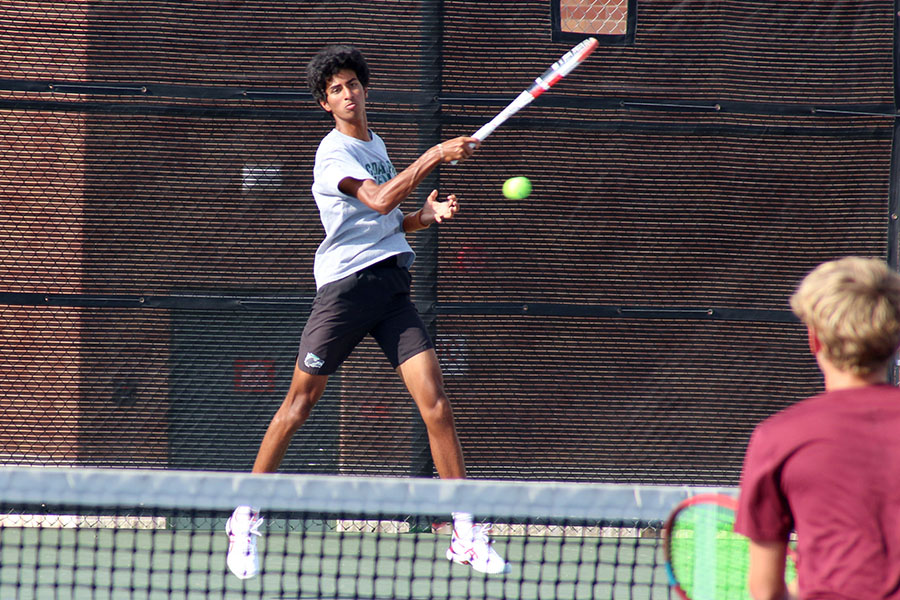 Hitting the ball across the court, senior Ganesh Sadasivan plays on Sept. 28. According to Sadasivan, the team had a close doubles match against Liberty Hill, but pushed through and succeeded. I didnt necessarily like having close matches in the moment, but looking back those are the ones that are the most rewarding, Sadasivan said. [Liberty Hill] was a challenging match because we were having an off day. However, we still managed to win in 
tie-break. In the moment, we both were definitely happy knowing that we gave it our all.