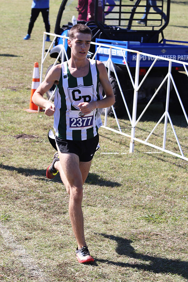 Running toward the finish line, senior Gareth Hopwood participates in the State competition on Nov. 5 at Old Settlers Park. The varsity boys team placed seventh, with an average of 16:44.2 minutes. 
“It felt pretty good, and it was super exciting [to compete at State],” Hopwood said. “Our goal is always to get to the State meet, and when we found out that we did when we won Regionals, it was awesome. I was really nervous and hyped. I’m glad I was able to [compete] with my team and that everybody was here today.”